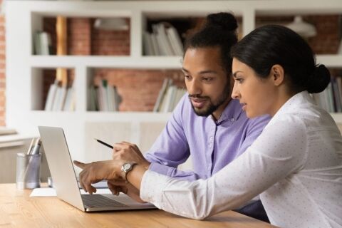 Close up confident Indian businesswoman mentor teaching African American intern